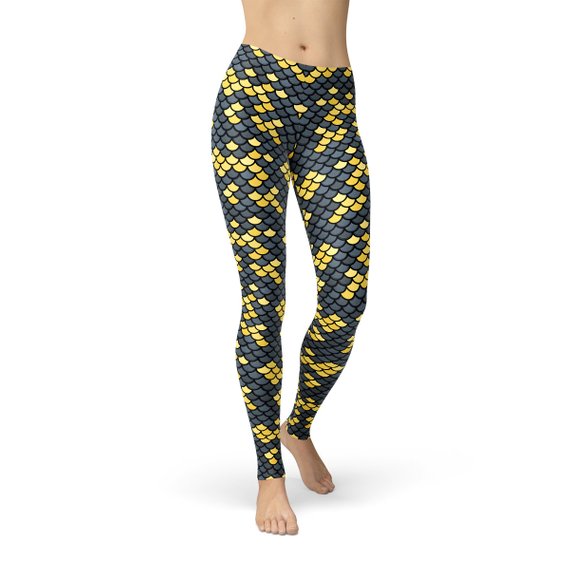 Fit woman wearing mermaid print leggings showing bright fish scales