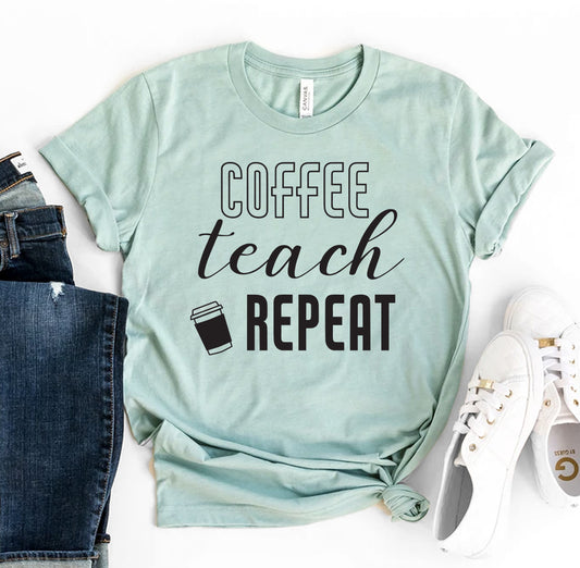 A light mint green t-shirt featuring bold black text that reads "Coffee Teach Repeat" with a small coffee cup graphic, styled casually with rolled jeans and white sneakers. The t-shirt is from the Bella Canvas brand, offering a soft, comfortable, and trendy look perfect for teachers and coffee lovers alike.